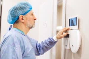 Medical staff using access badge to enter a secure door