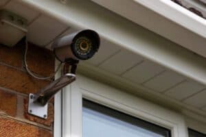 Outdoor security camera mounted on a wall under eaves