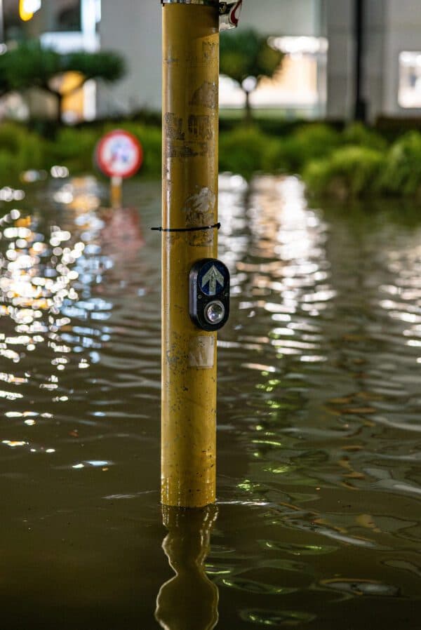 Submerged parking indicator pole demonstrating environmental flooding risk