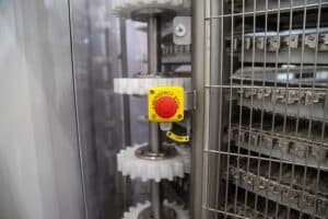 Emergency stop button installed near safety machinery grid