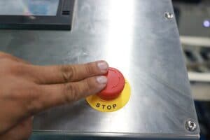 Industrial control unit emergency panic switch being pressed