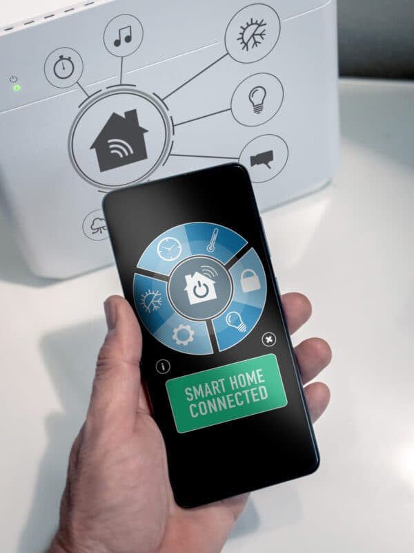 Hand holding mobile smartphone running smart security app dashboard