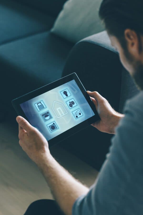 Business owner analyzing property sensors using tablet interface