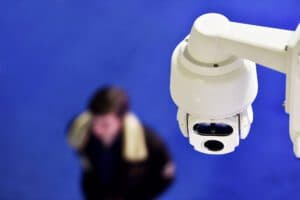 Top down perspective of dome surveillance camera looking at pedestrian walking