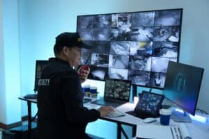 Security supervisor using desktop terminal with surveillance feed search software