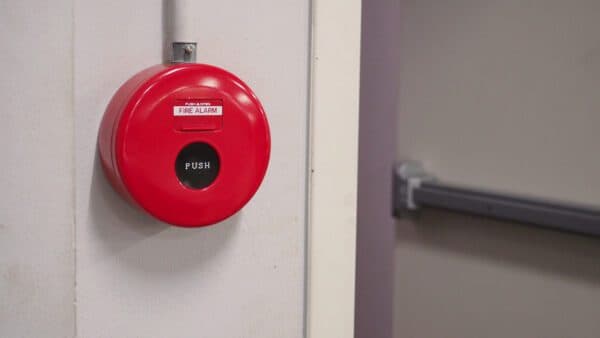 Red fire alarm wall bell and push station