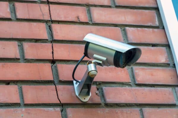 Outdoor security camera dome on brick wall