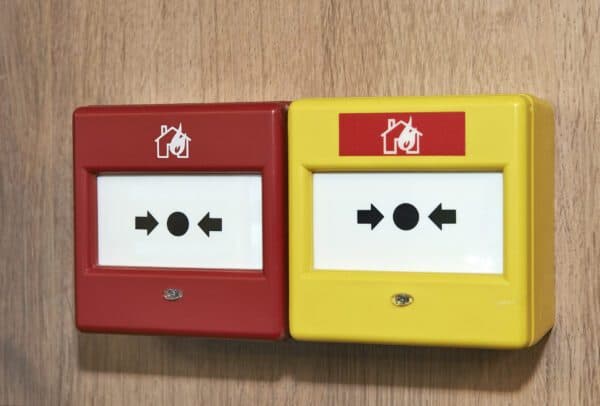 Red and yellow wall-mounted emergency fire alarm and panic buttons