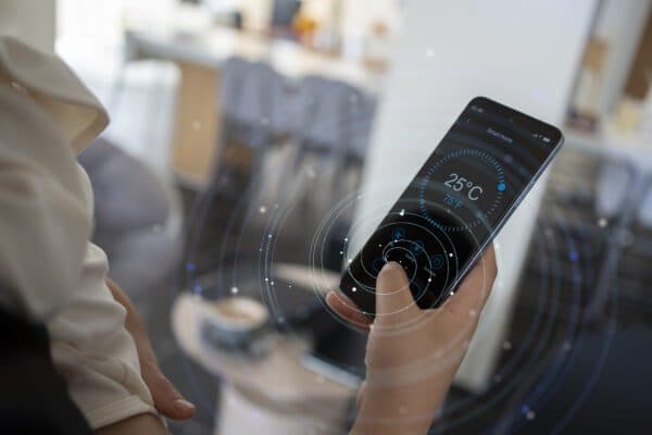 Close-up of smart phone displaying temperature monitoring levels