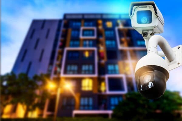 Security dome camera installed outside modern multi-family apartment building