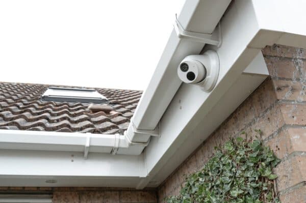 Security camera mounted on exterior corner of housing building