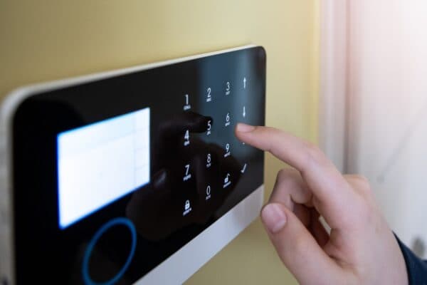 Entering a security pin on a wall-mounted alarm system keypad in a pharmacy office