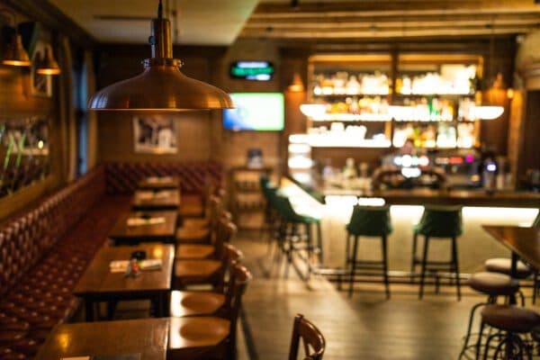 Warmly lit restaurant bar seating area under surveillance