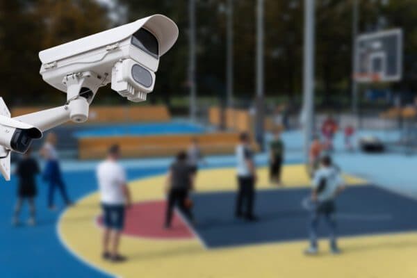 Outdoor security camera overseeing school playground and basketball court